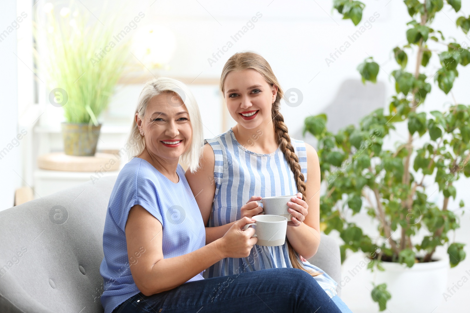 Photo of Mother and her adult daughter spending time together at home