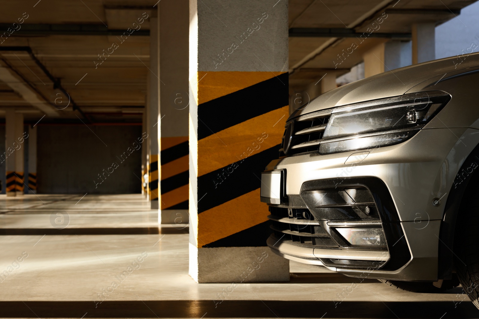 Photo of Open parking garage with car on sunny day