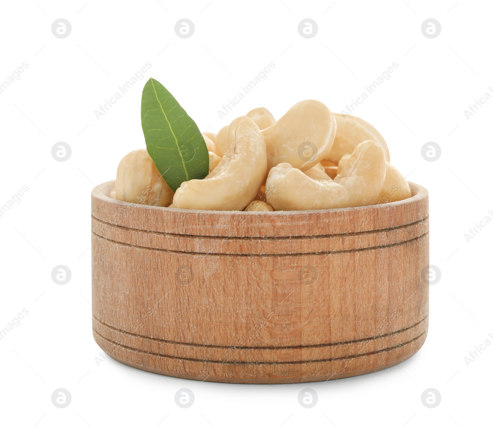 Photo of Bowl of tasty organic cashew nuts and green leaf isolated on white