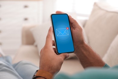 New message notification. Man with mobile phone indoors, closeup