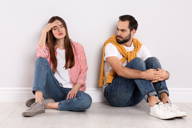 Photo of Unhappy young couple with relationship problems indoors