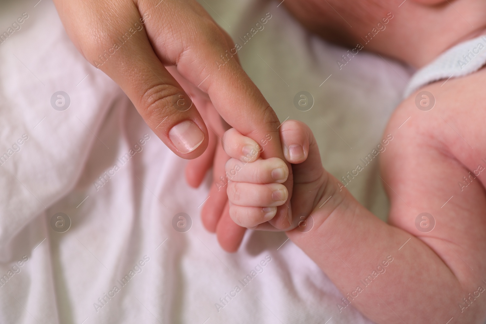 Photo of Mother and her newborn baby on bed, closeup