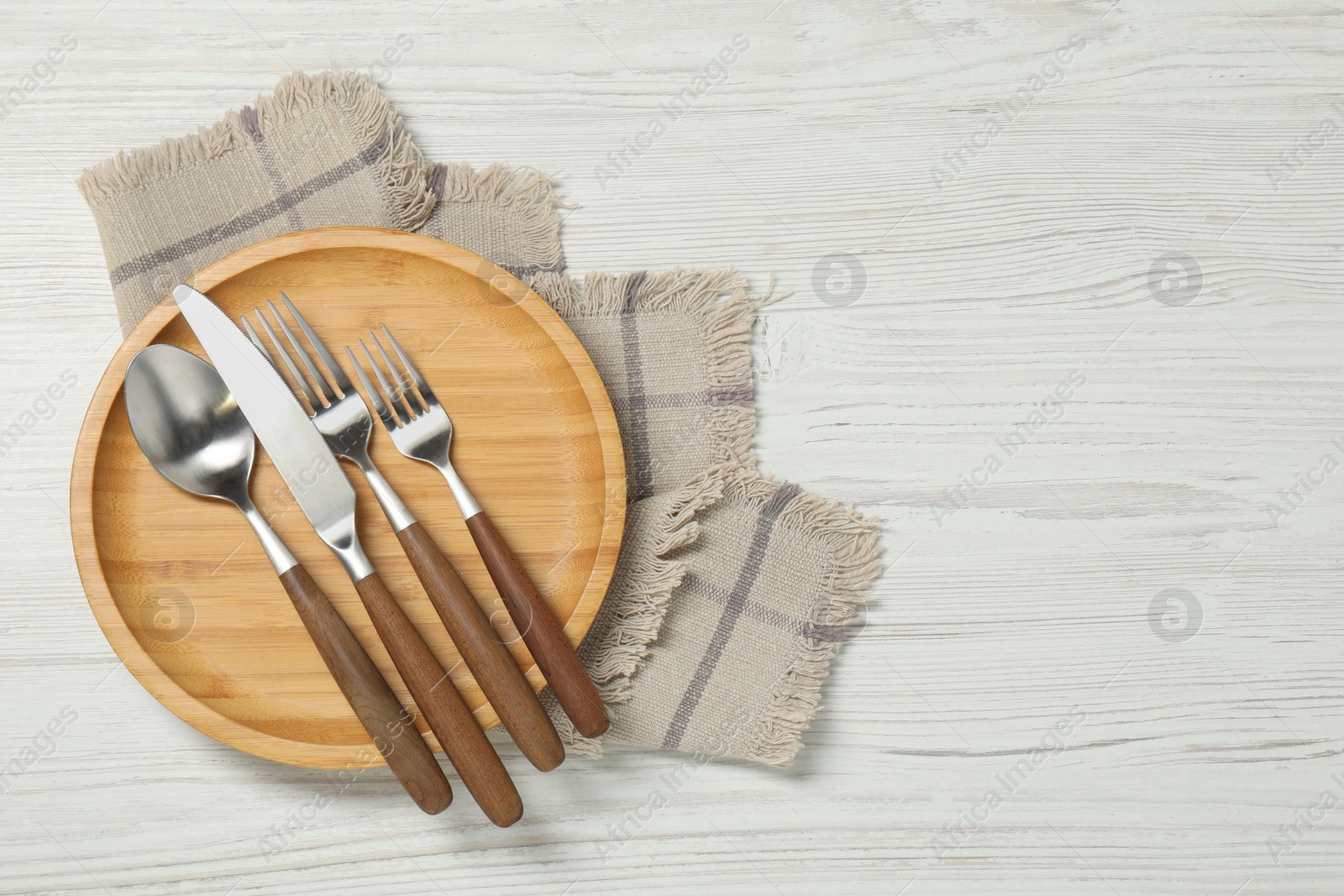 Photo of Stylish setting with elegant cutlery on white wooden table, top view