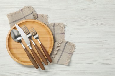 Photo of Stylish setting with elegant cutlery on white wooden table, top view