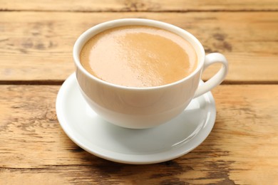 Photo of Cup of aromatic coffee on wooden table, closeup