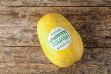 Whole ripe spaghetti squash on wooden background, top view