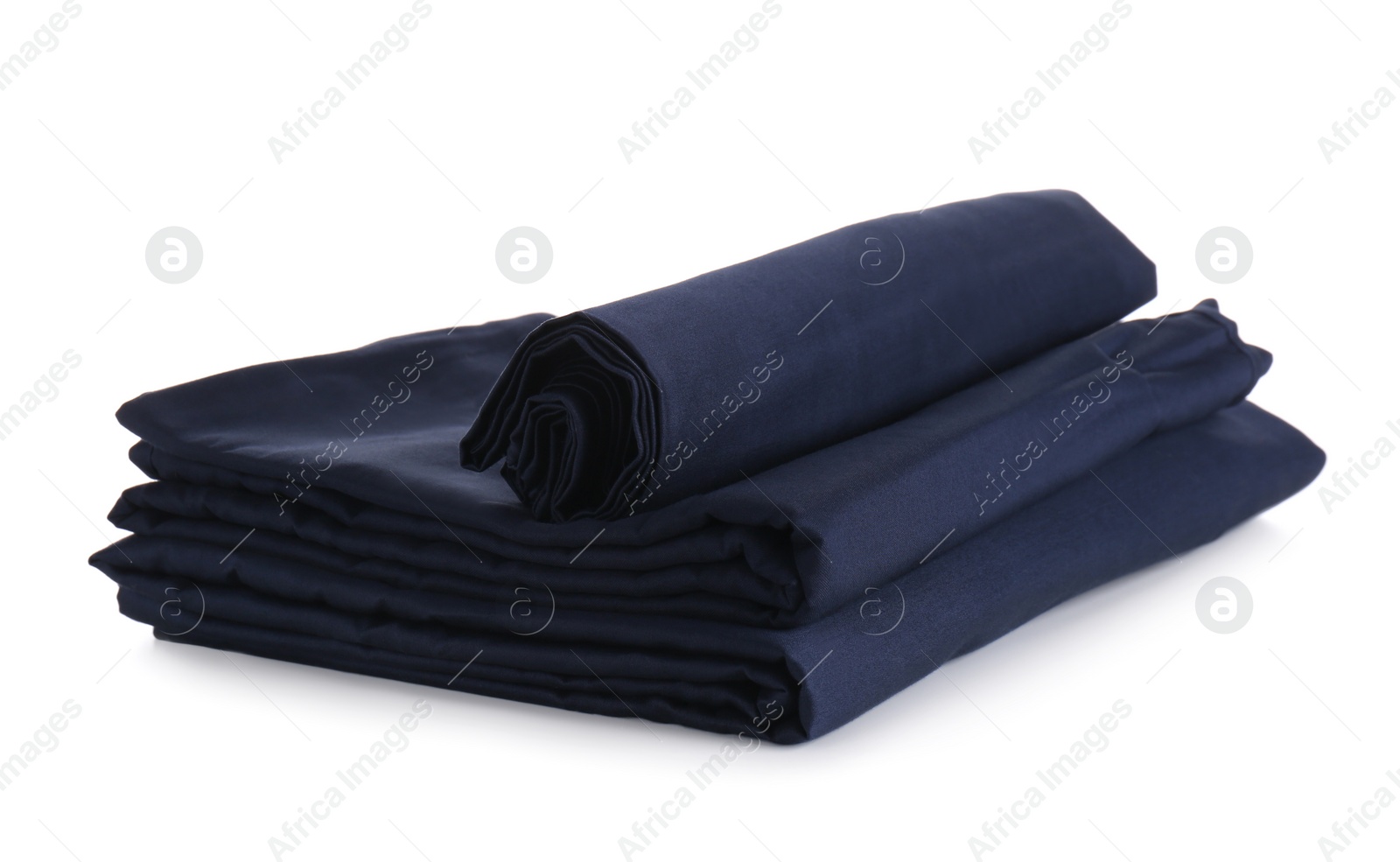 Photo of Stack of clean silky bed linen isolated on white