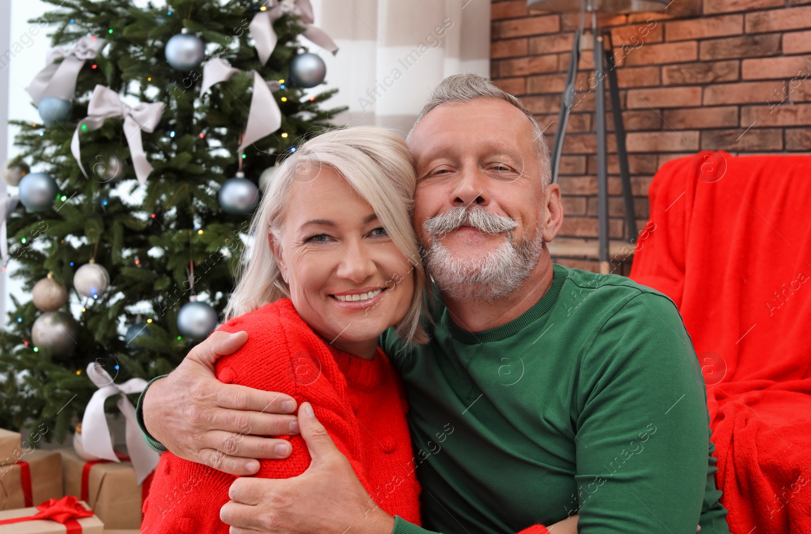 Photo of Happy mature couple hugging at home. Christmas celebration