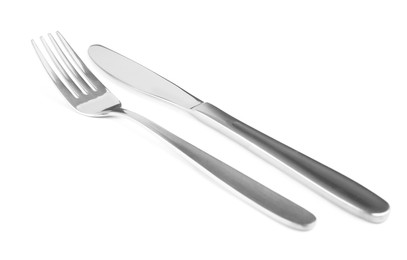 Photo of Shiny fork and knife on white background