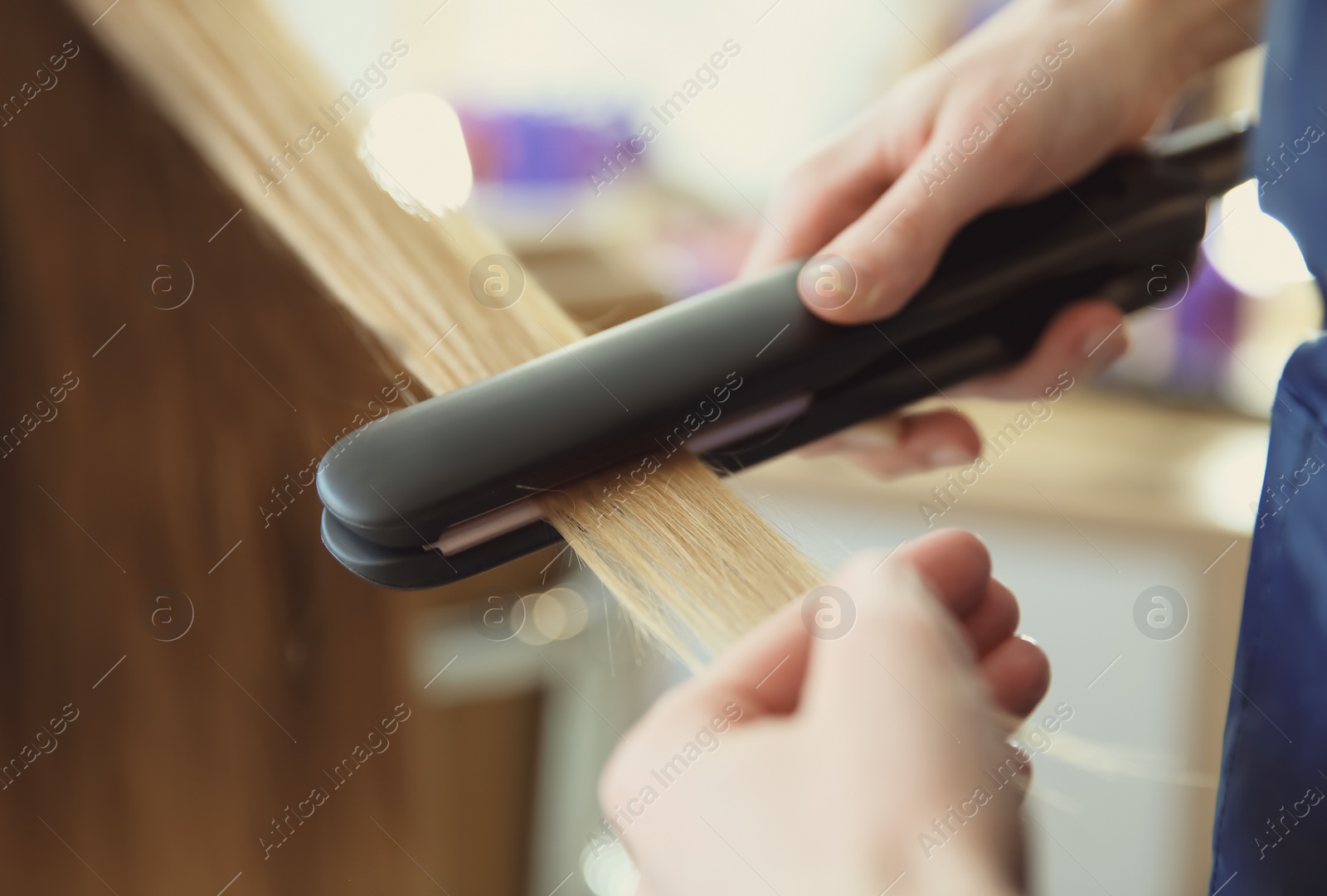 Photo of Professional hairdresser working with client in salon