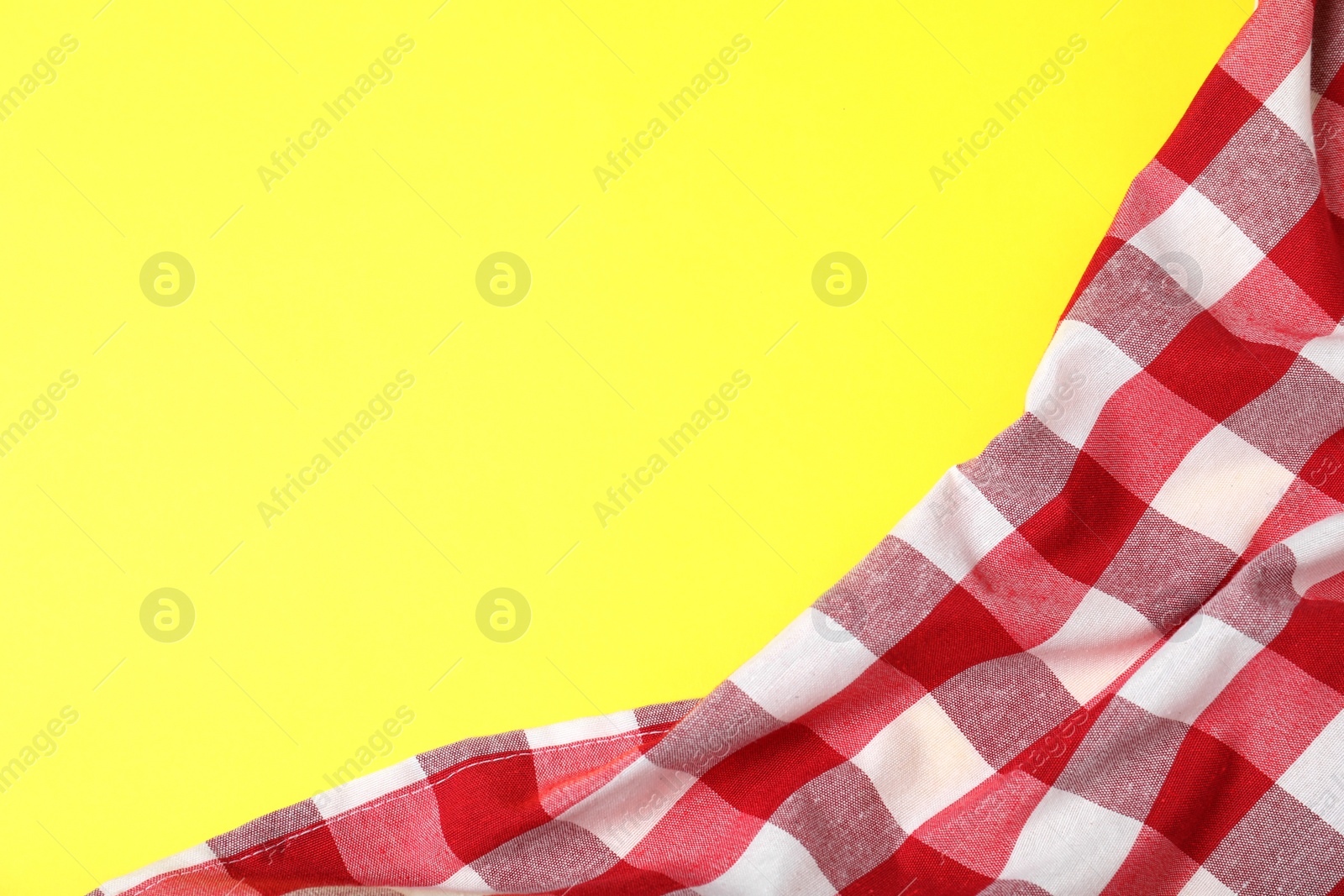 Photo of Checkered picnic blanket on color background, top view. Space for text