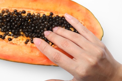 Photo of Young woman touching half of papaya on white background, closeup. Sex concept