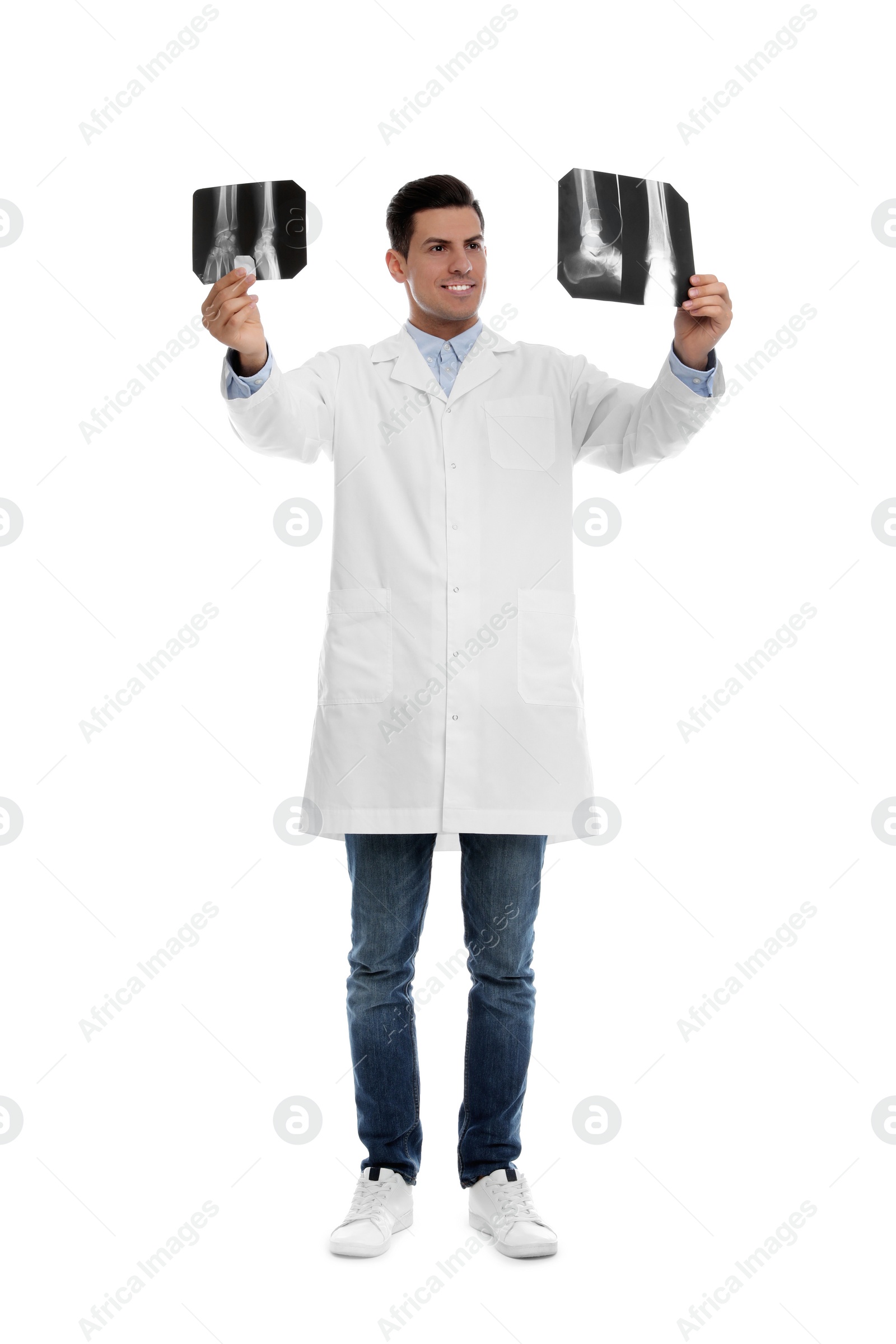 Photo of Orthopedist holding X-ray pictures on white background