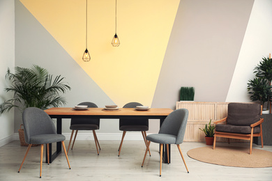 Photo of Modern wooden dining table in room interior