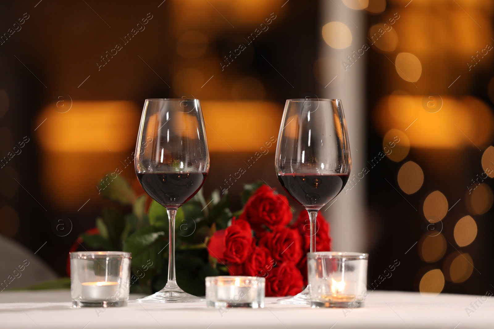 Photo of Glasses of wine for romantic dinner on table in restaurant