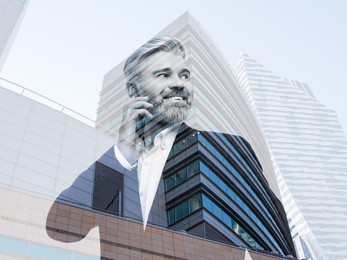 Double exposure of businessman talking on phone and office buildings