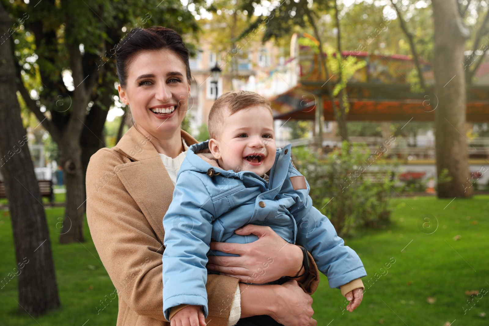 Photo of Portrait of happy mother with her son in park