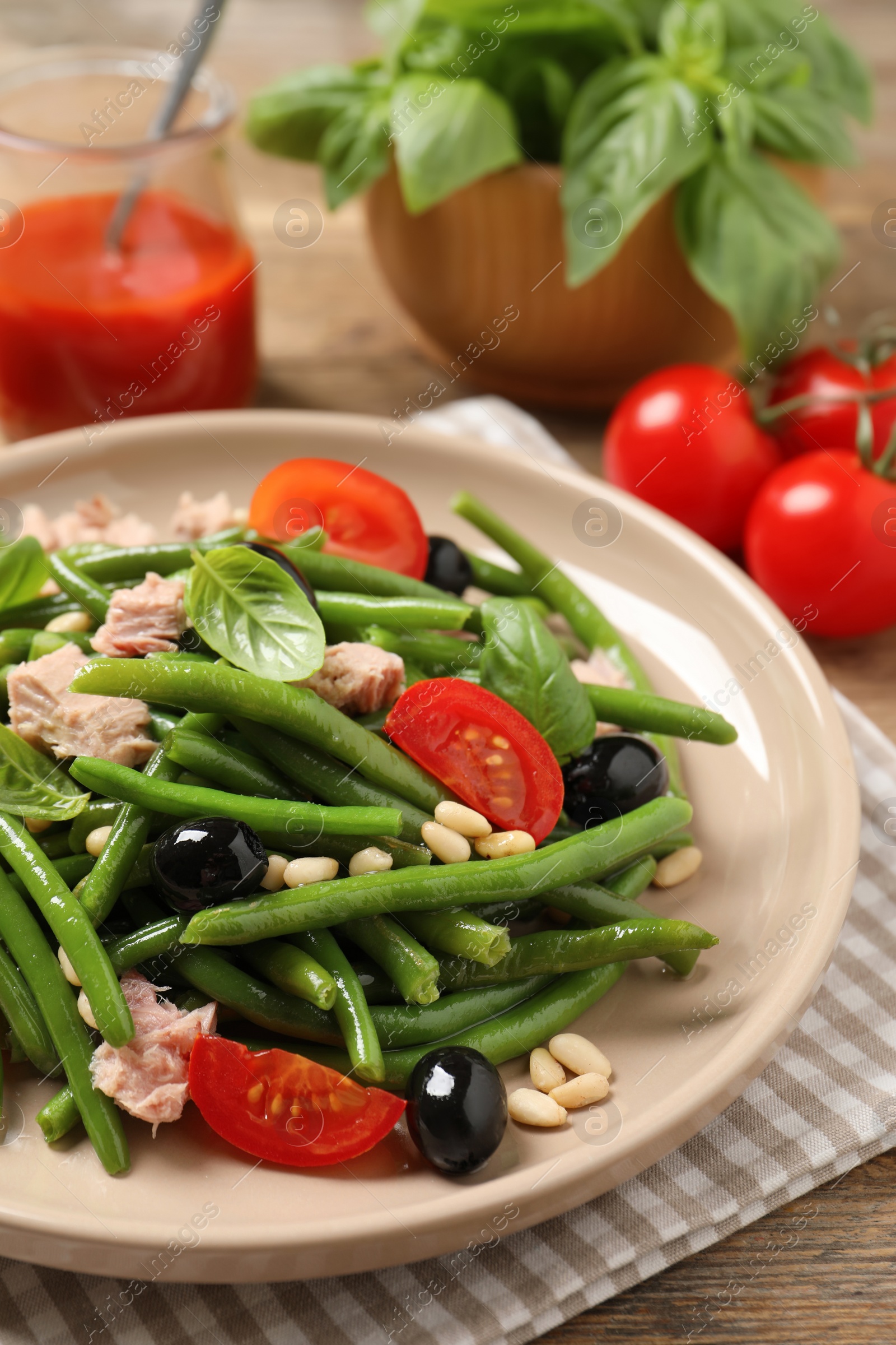 Photo of Tasty salad with green beans on table