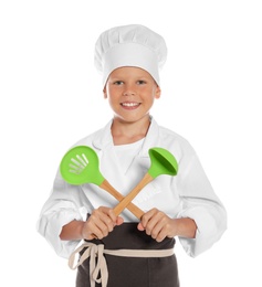 Photo of Portrait of little boy in chef hat with cooking utensils on white background