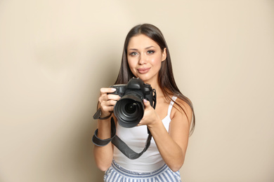 Photo of Professional photographer working on beige background in studio