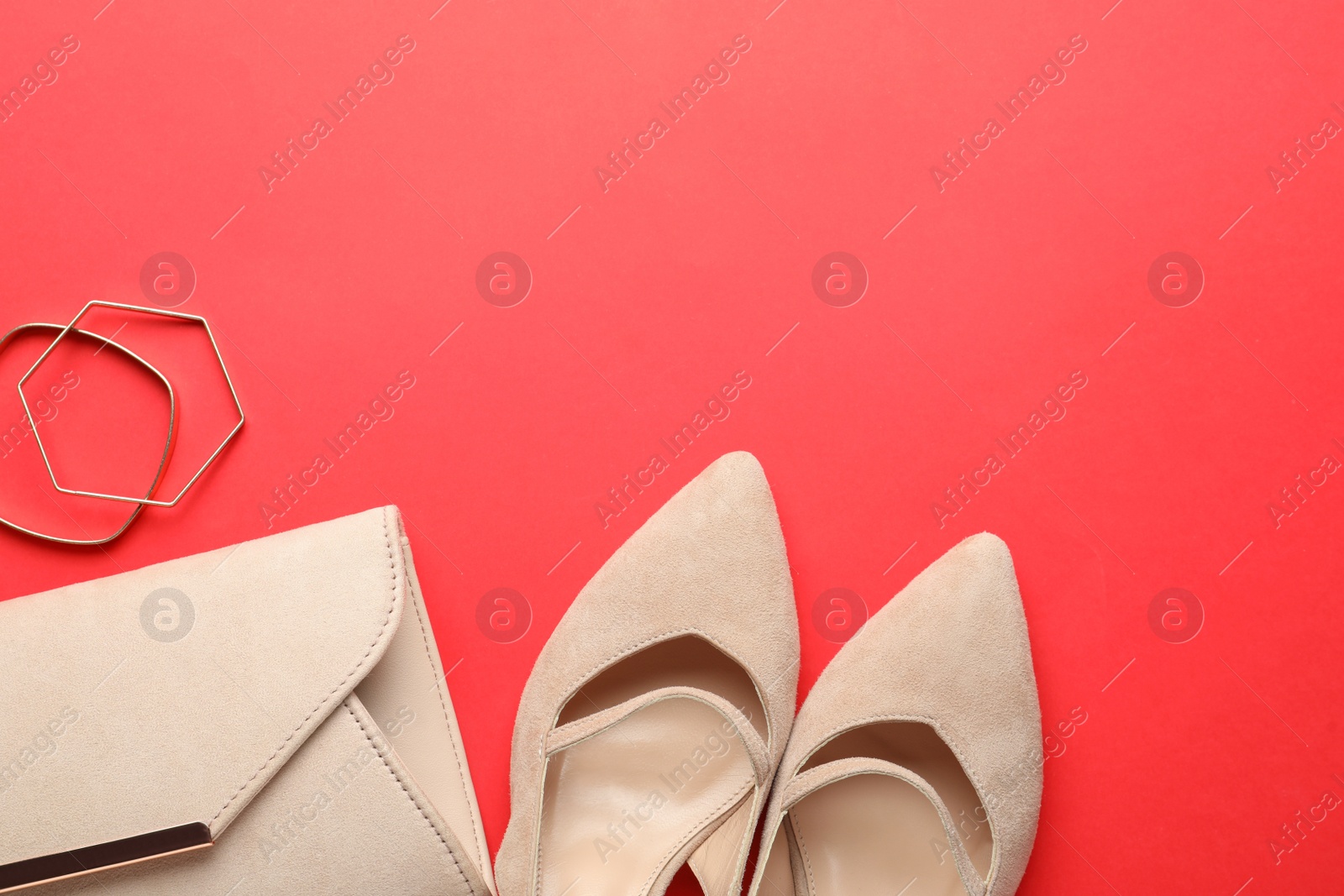 Photo of Flat lay composition with stylish women's shoes and accessories on red background, space for text