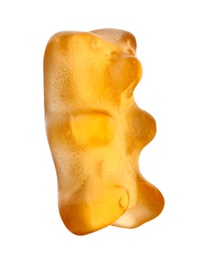 Photo of Delicious orange jelly bear on white background