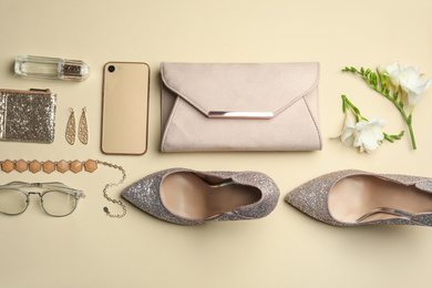 Photo of Flat lay composition with stylish woman's bag, smartphone and accessories on beige background