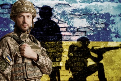 Image of Military and old wall painted in colors of Ukrainian with silhouettes of soldiers