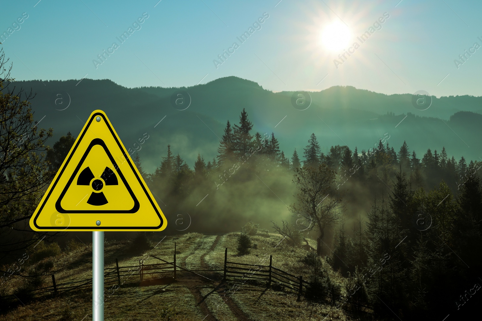 Image of Radioactive pollution. Yellow warning sign with hazard symbol in mountains