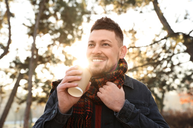 Photo of Man with cup of coffee in morning outdoors