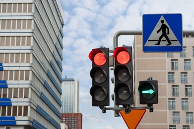 Photo of Traffic lights and Pedestrian Crossing road sign in city