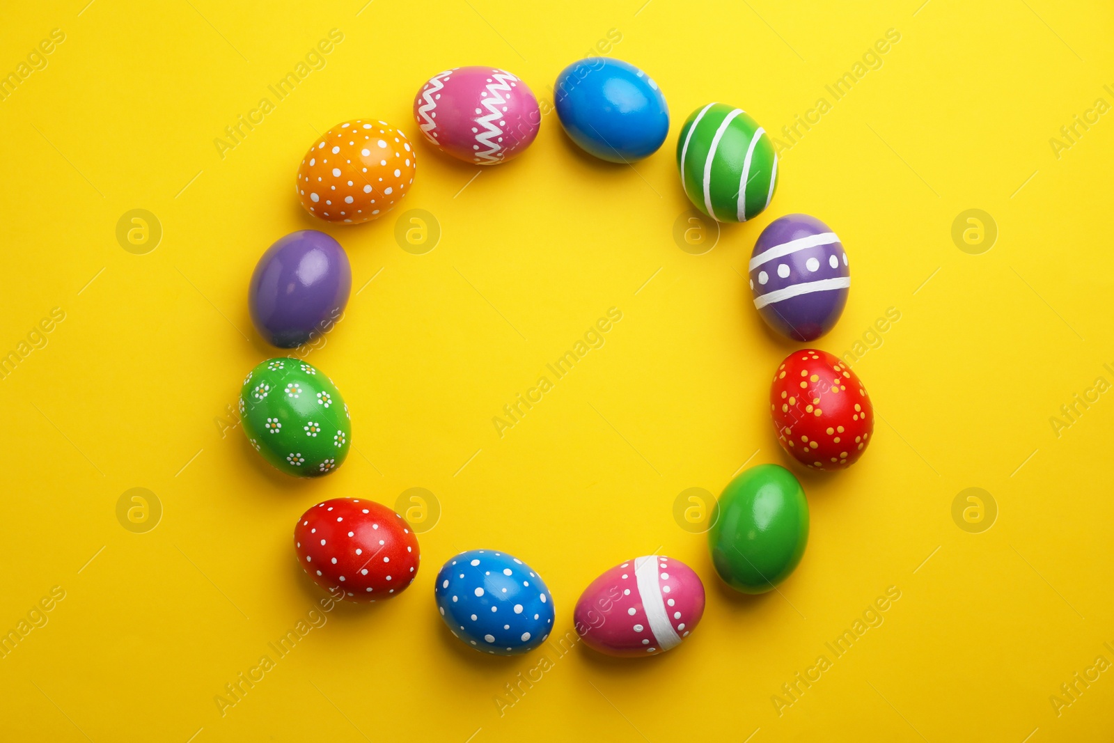 Photo of Decorated Easter eggs and space for text on color background, top view