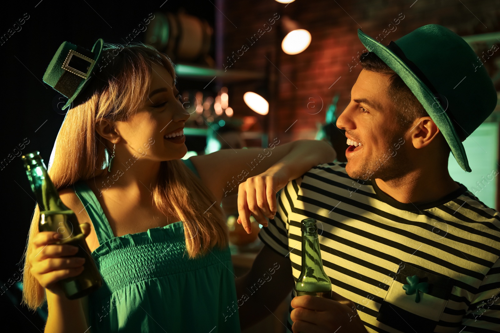 Photo of Couple with beer celebrating St Patrick's day in pub