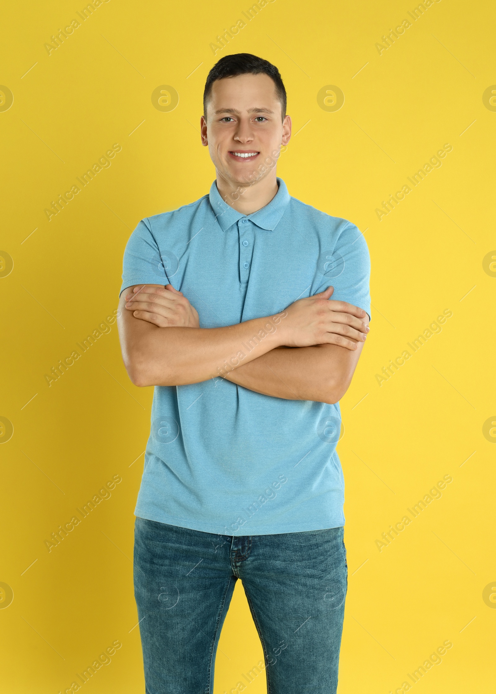 Photo of Happy handsome young man on yellow background