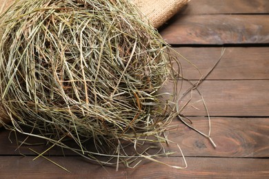 Photo of Dried hay on wooden table, closeup. Space for text