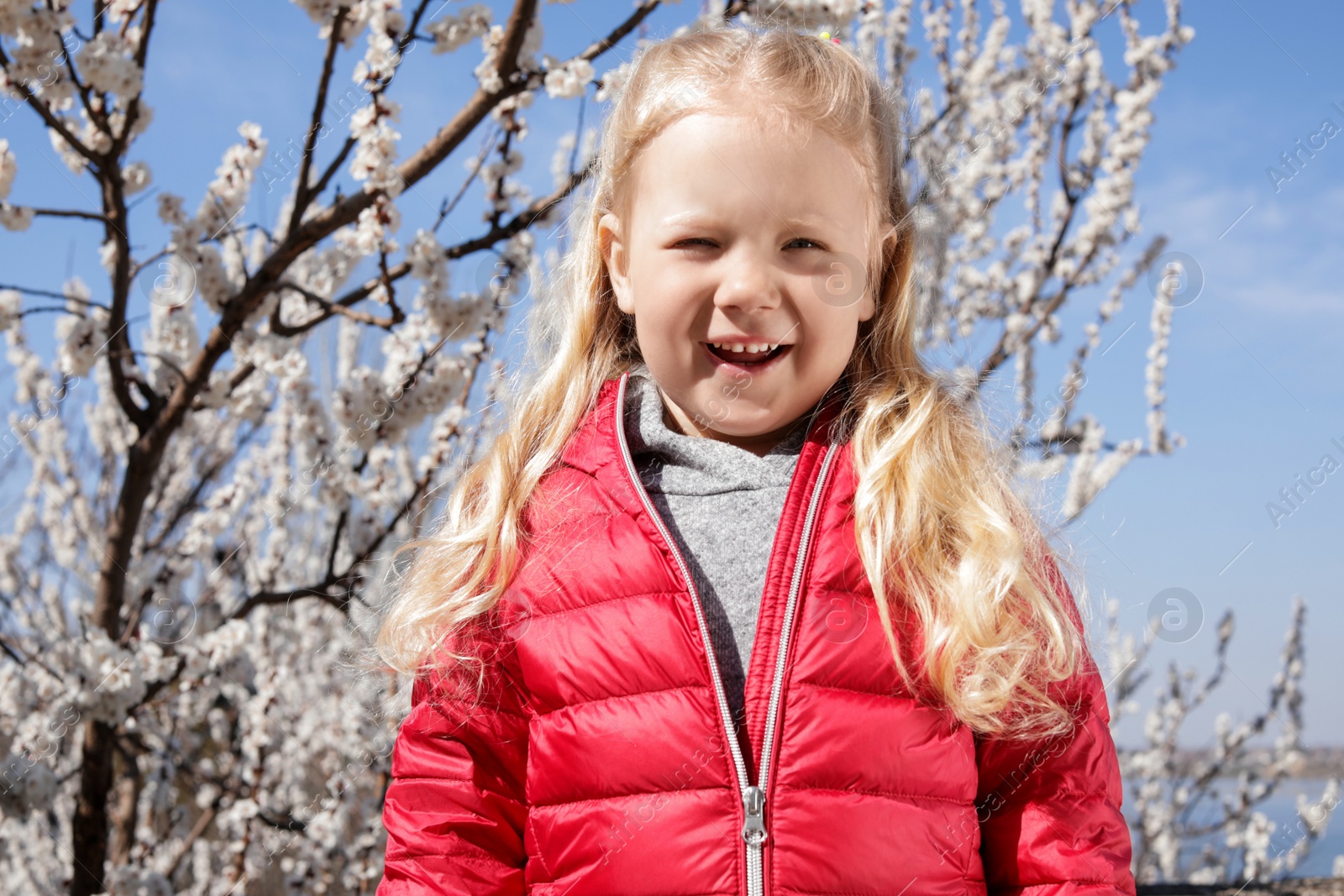 Photo of Happy healthy little girl enjoying springtime outdoors. Allergy free concept