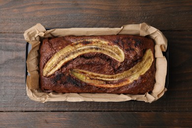 Delicious banana bread on wooden table, top view