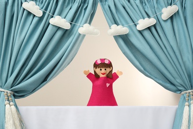 Photo of Creative puppet show on white stage indoors