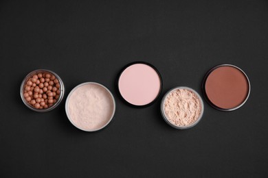 Photo of Different face powders on black background, flat lay