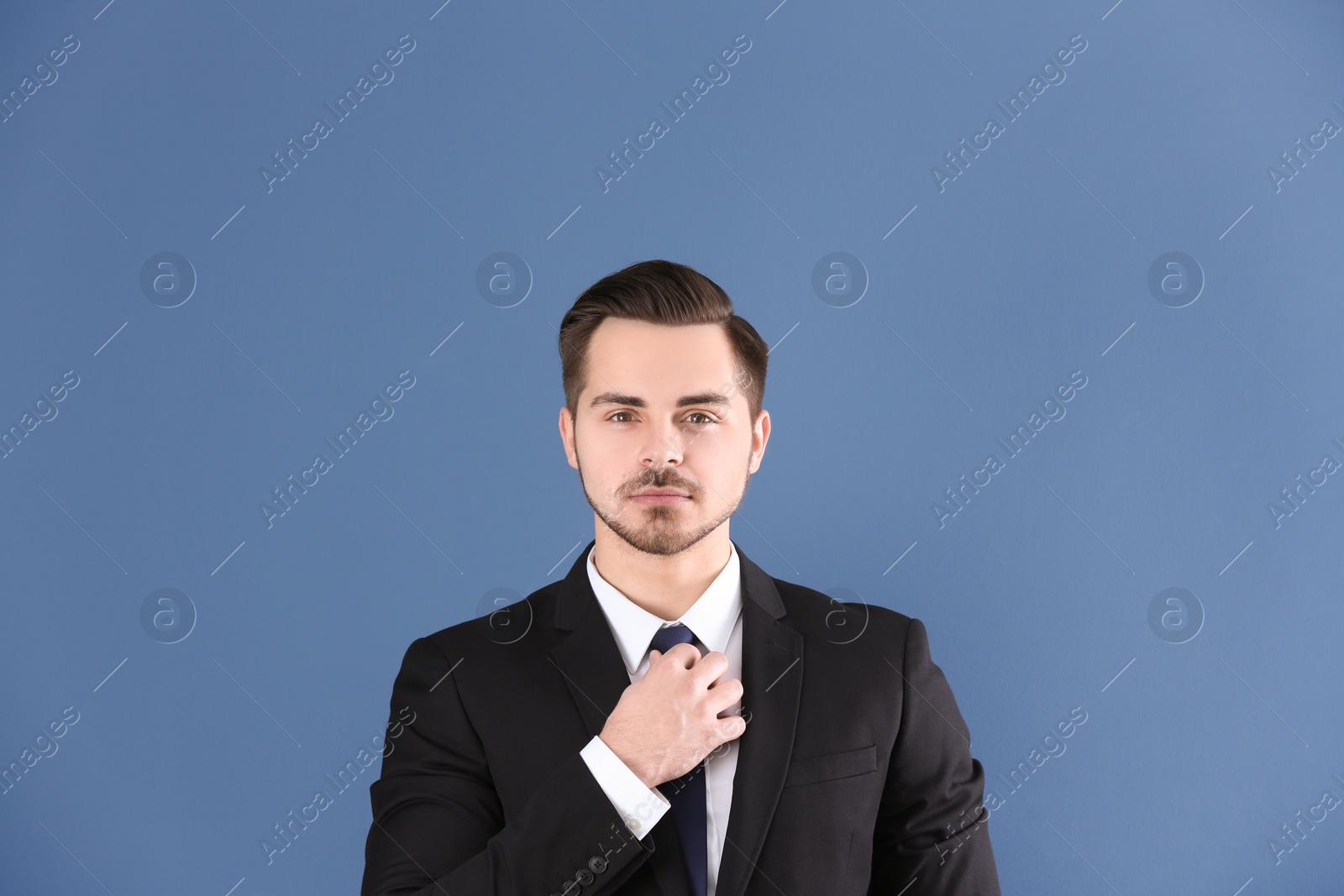 Photo of Portrait of young man with beautiful hair on grey background