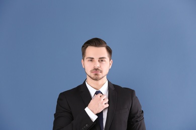 Portrait of young man with beautiful hair on grey background