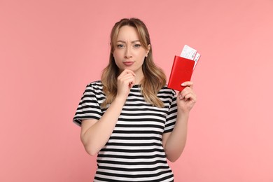 Photo of Young woman with passport and ticket on pink background