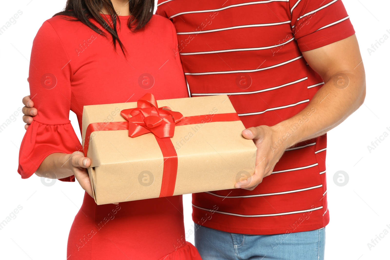 Photo of Young happy couple with gift box on white background. Christmas celebration