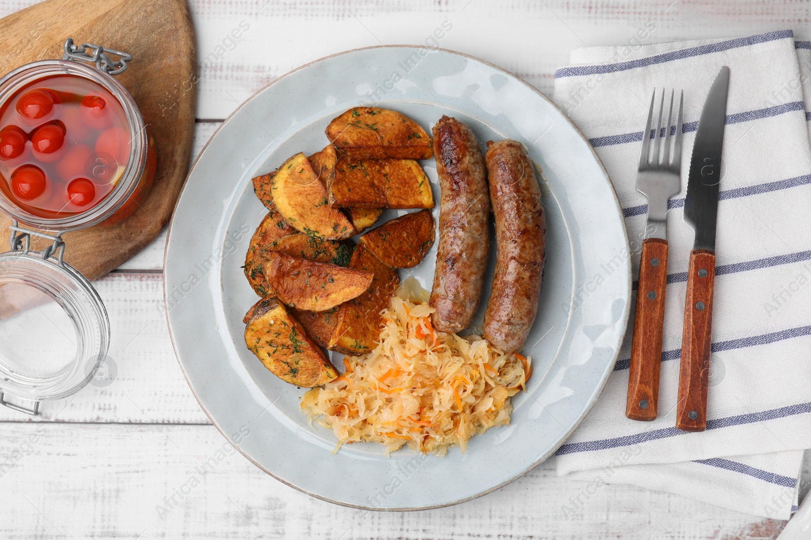 Photo of Plate with sauerkraut, sausages and potatoes on white wooden table, flat lay