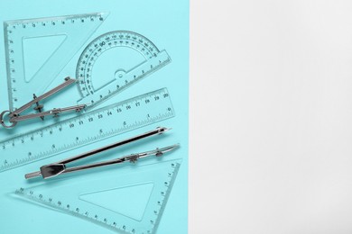 Photo of Different rulers and compasses on color background, flat lay. Space for text