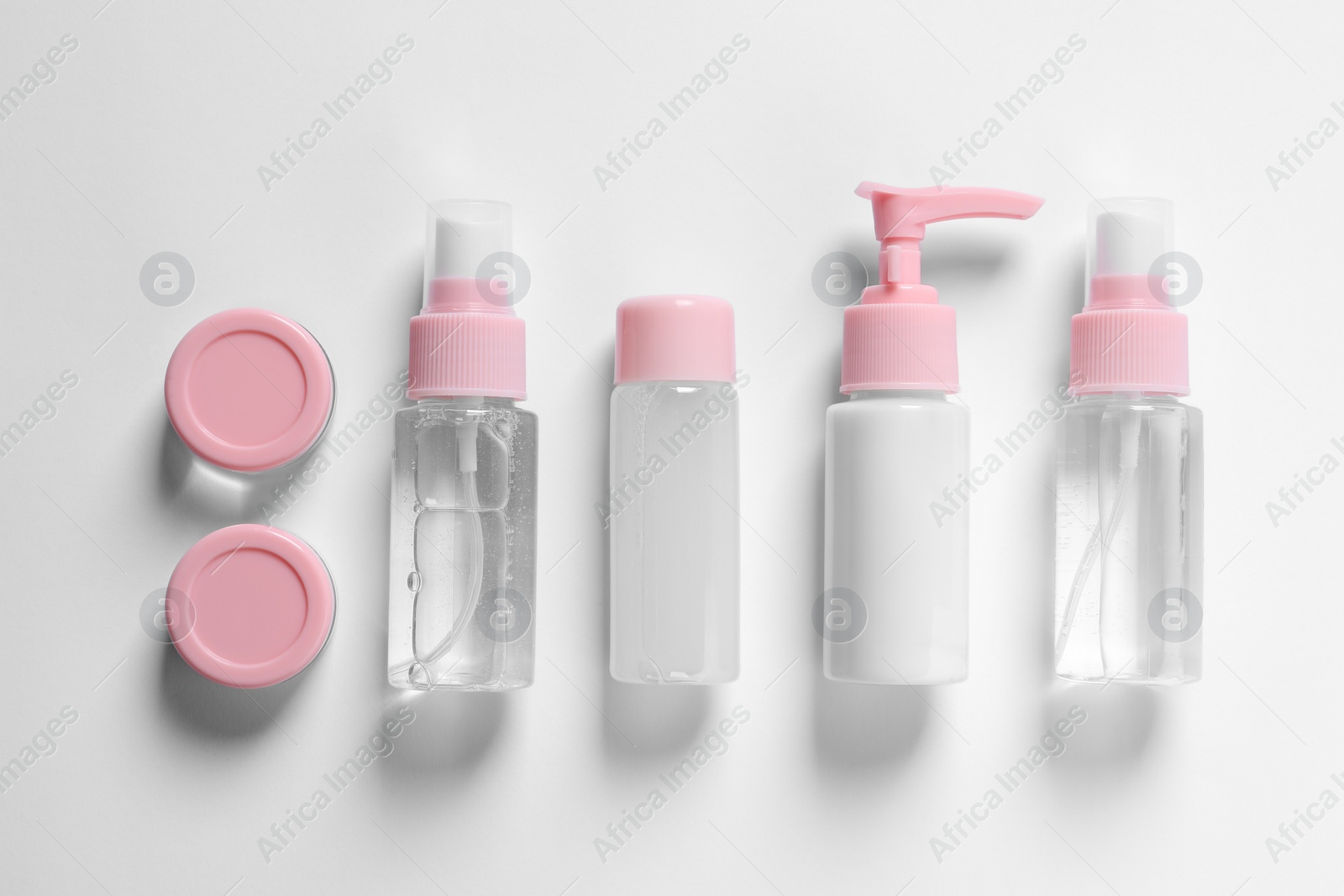 Photo of Cosmetic travel kit on white background, flat lay