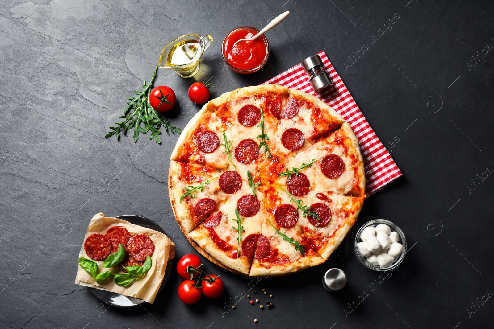 Photo of Flat lay composition with hot pepperoni pizza on dark table