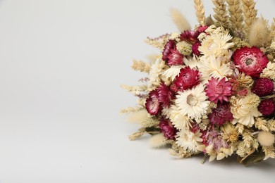 Beautiful bouquet of dry flowers on white background, space for text