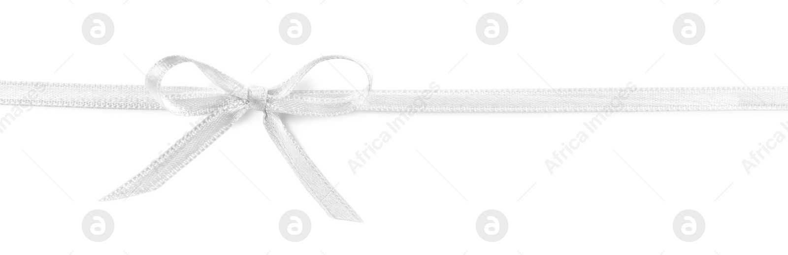 Photo of Satin ribbon with bow on white background, top view