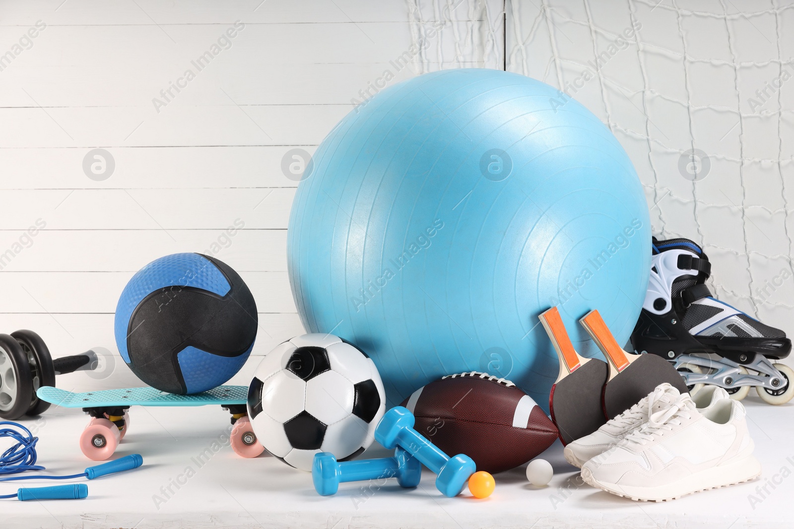 Photo of Many different sports equipment on white table